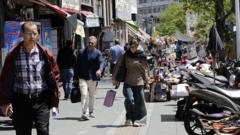 Daily life in Tehran continues - but money is short and risk of war looms