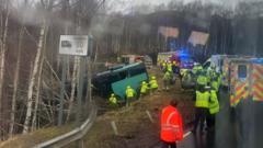 Two in hospital after bus crashes down embankment in the Highlands